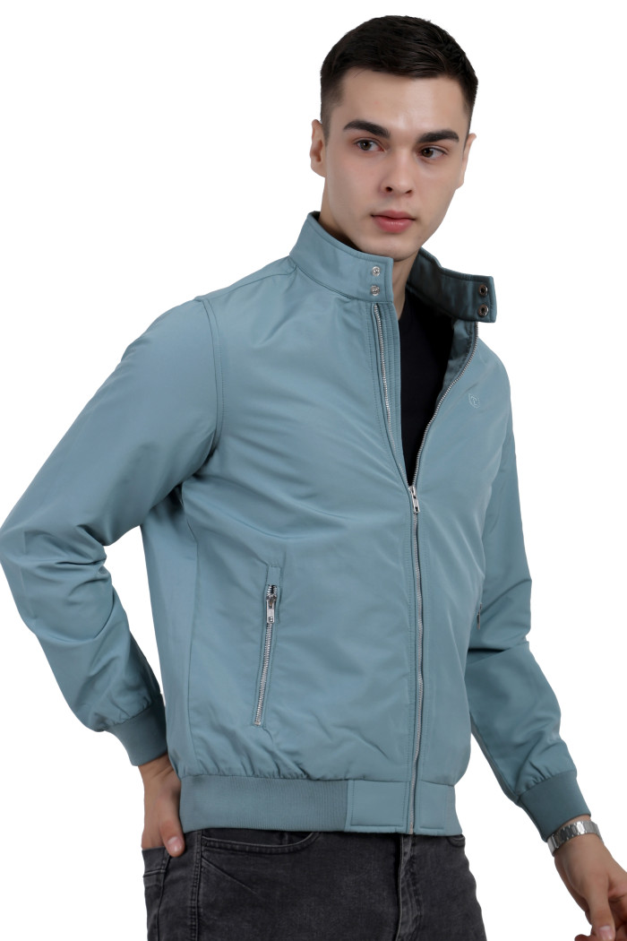 A right pose of a man wearing an Aqua BlueFinish Lightweight Jacket with high neck collar, zipper closure and pocket in hand designed for casual winter layering and comfort.